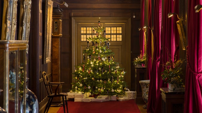 Christmas tree and old master paintings in the hall at Polesden Lacey
